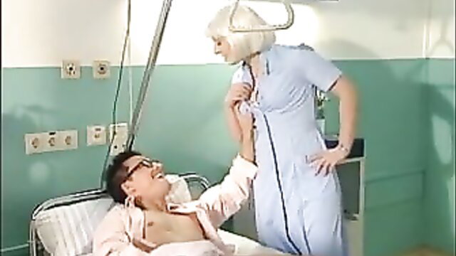 Blonde nurse in uniform examines shirtless male patient in psycho clinic