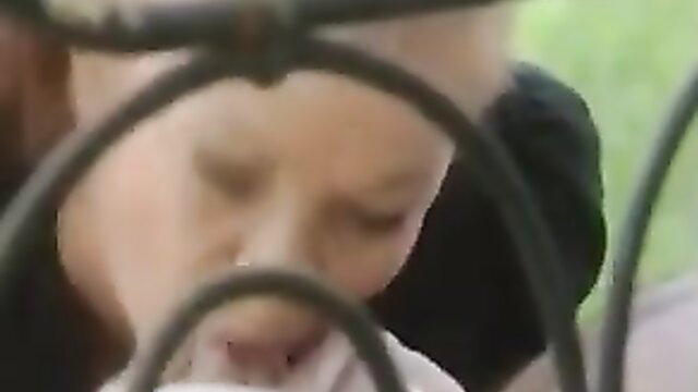 Blurry close-up of mature French granny behind bars in 90s porn thumbnail