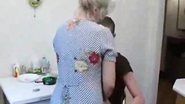 Grandma and grandson intimate in the kitchen