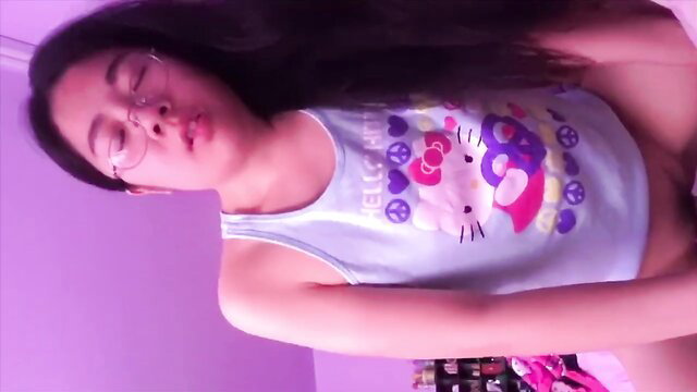 Asian girl in Hello Kitty tank top, glasses, long black hair, explicit pose