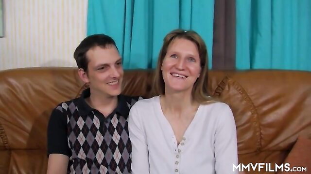 Real amateur German couple smiling on couch in homemade sex video