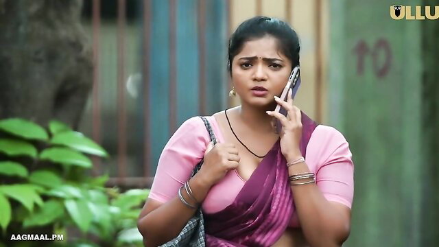 Indian cougar in tight pink saree blouse on phone, deep cleavage tease
