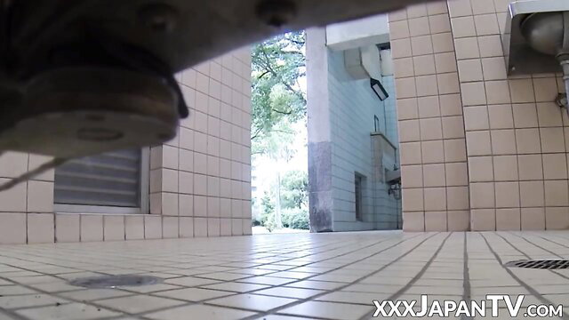 Oriental hottie caught peeing in public toilet POV