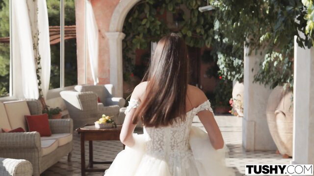 Sybil in elegant white lace wedding dress, elegant outdoor pose