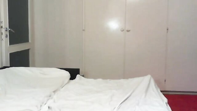 Very Cute Crossdresser in Red High Heels on Bed