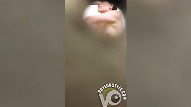 Topless swimmer with nice tits exposing in steamy locker room