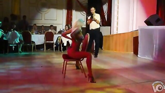 Blonde stripper in red bodysuit performs sexy leg spread at wedding