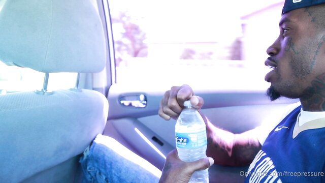 NyNy Lew tatted black guy in car holding water bottle, sexy gaze