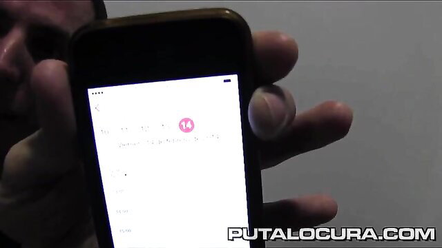 Blurry closeup of hand holding phone showing amateur couple chat