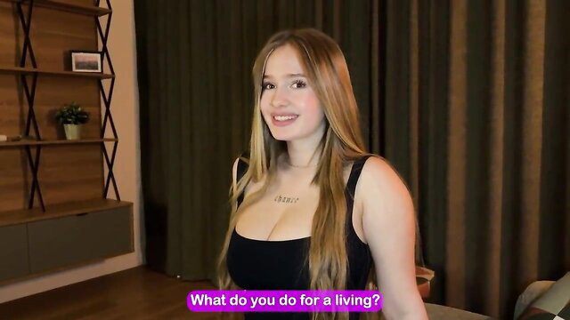 Blonde student beauty in tight black tank top smiles at 'What do you do for living?'