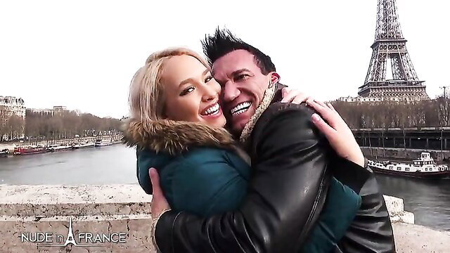 Blonde and brunette couple hugging on Paris honeymoon by Eiffel Tower