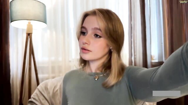 Blonde teen in grey sweater takes selfie in bedroom softcore