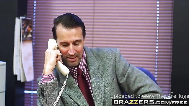 Handsome suited man in suit and tie on office phone call