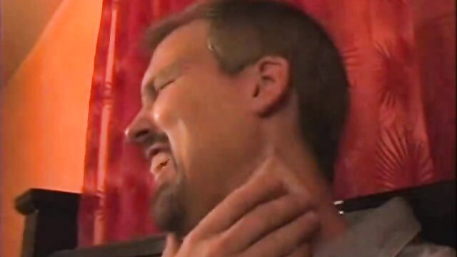 Man grimacing in ecstasy, hand on neck in intense hypnosis homecare scene