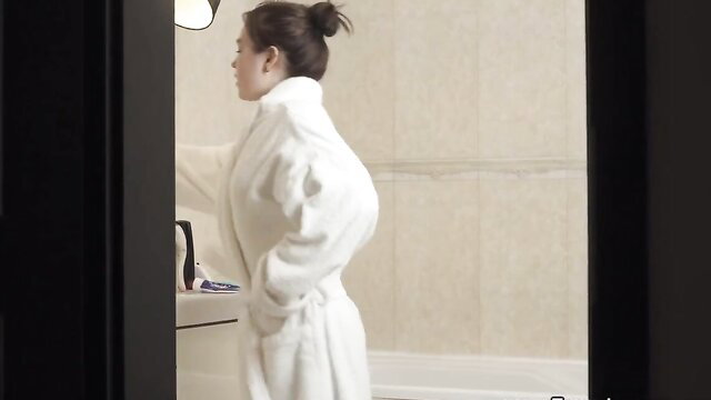 Nubile Asian beauty in white bathrobe by sink, sexy bathroom tease