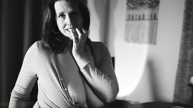 Mature MILF pastor wife smiles seductively, exposing huge cleavage