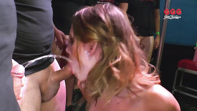 Blonde woman gulping piss from cock in German pissathon gangbang