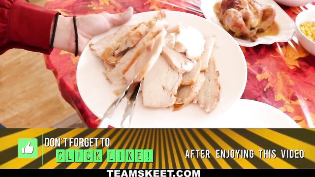 Sliced turkey on Thanksgiving plate, hands serving food