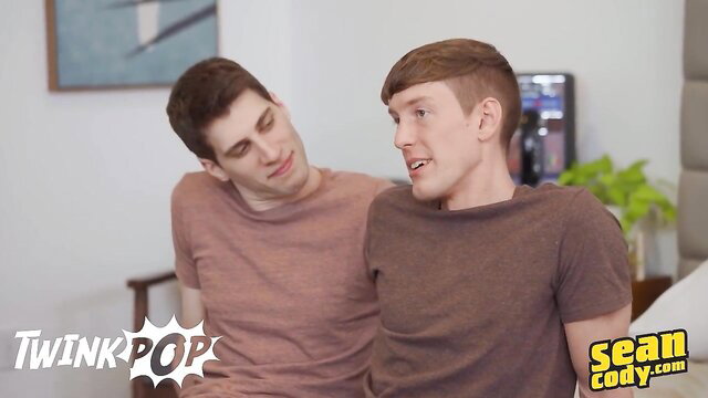 Two cute twink guys Sean and Cody cuddling shirtless on bed