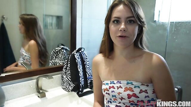 Selena Love in butterfly tube top, smiling in bathroom mirror selfie