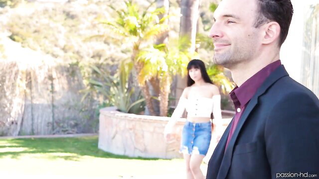 Asian girl in tiny skirt and top teases suited white guy outdoors