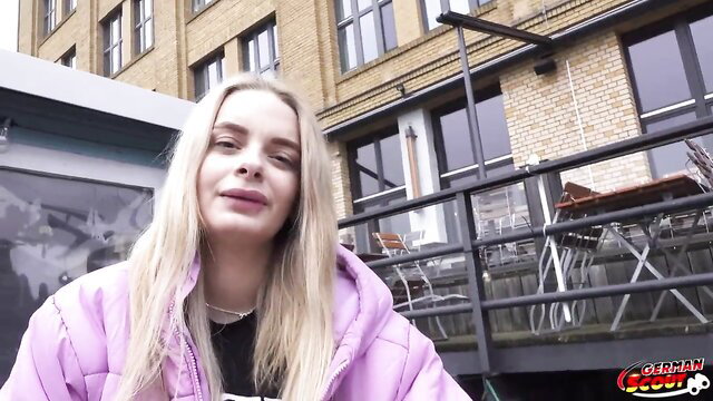 Naomi Love blonde nurse in pink puffer jacket smiles at German Scout casting