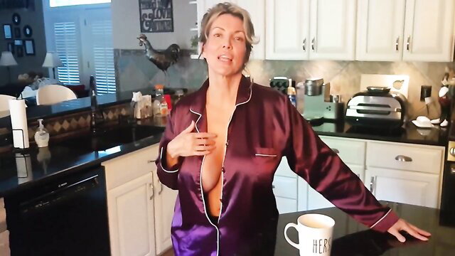 Blonde MILF in open silk robe exposing cleavage in kitchen tease
