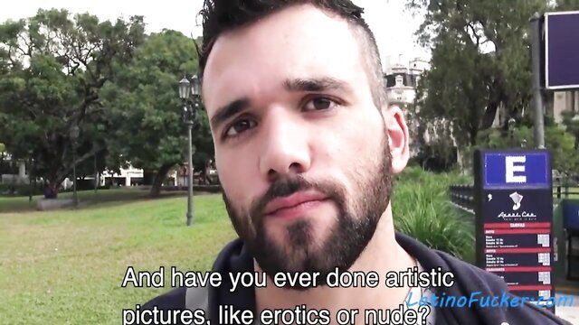 Handsome bearded Latino guy with undercut in park asked about erotic nude art pics