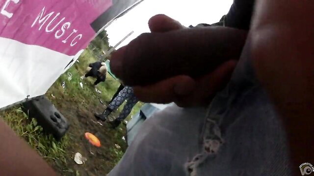 Man strokes thick black cock near peeing party girls at music fest
