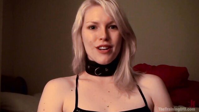 Blonde Ella Nova in black choker collar, teasing BDSM look