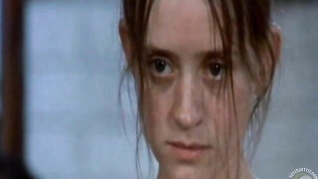 Wet-haired mature nun with intense gaze in humiliation scene