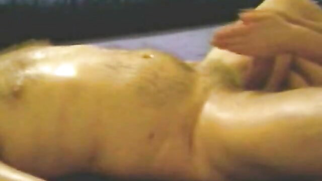 Hot Asian masseuse gives oily handjob to naked man in parlor