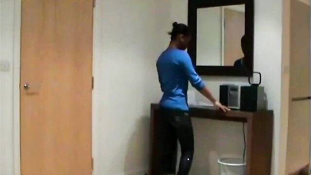 British black man in tight blue top and pants at mirror, fetish discipline thumbnail