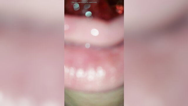 Closeup of woman's open mouth with teeth and tongue, swallowing gummy