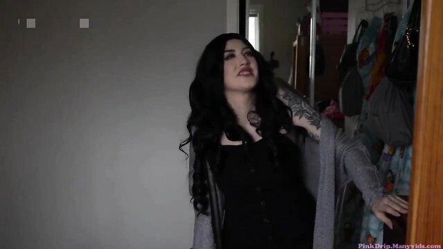 Pink Drip in black dress and cardigan by closet, goth tease