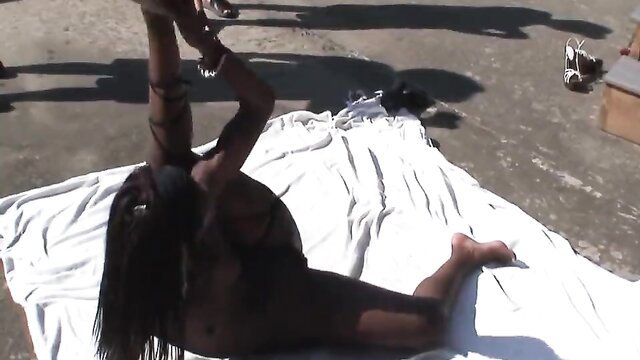 Black stripper babe nude yoga pose at outdoor party