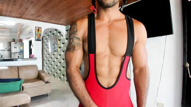 Muscular Latino jock in red singlet showing bulge, hot abs
