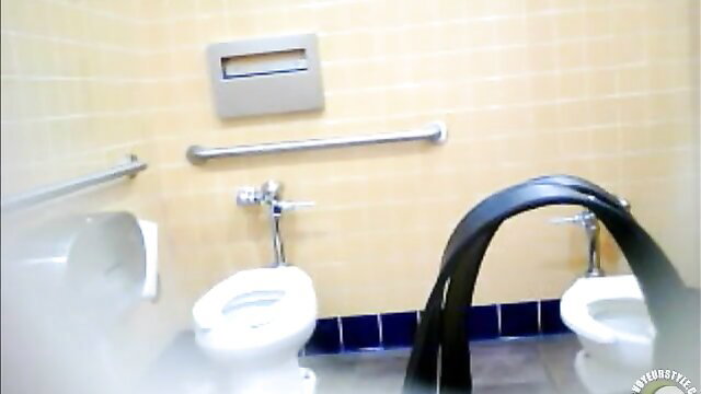 Bootylicious black MILF pees in restroom urinals