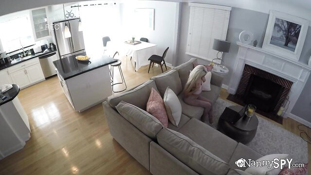 Petite blonde nanny in pink panties sits on couch with bearded man
