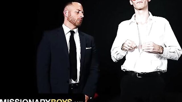 Suited daddy eyes twink's open shirt exposing chest in gay tease