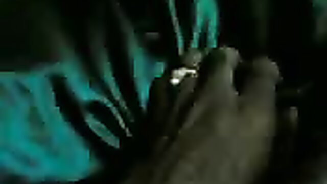 Skinny Indian granny hand with ring closeup in dim green light