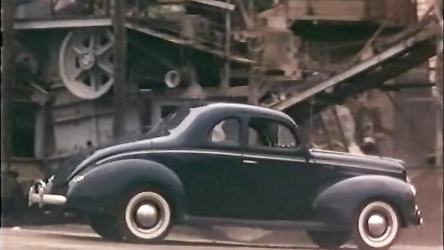 Vintage 1979 Sizzle movie poster: sleek black 1940s coupe in gritty factory