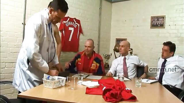 Muscular doc in lab coat serves men in soccer gear at table amateur scene