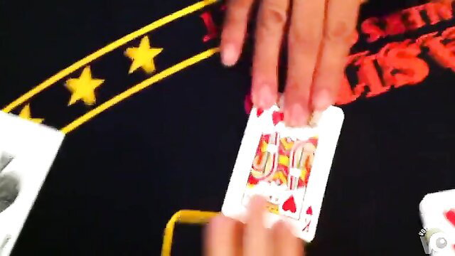 Naked Asian hands revealing ace of diamonds at wild basement party