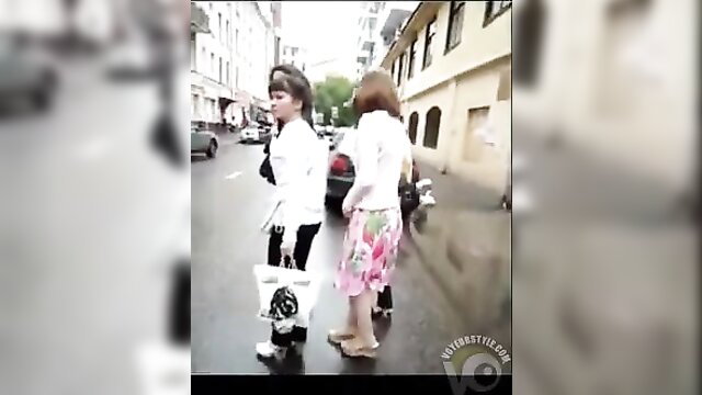 Two brunettes in skirts and heels walking, asses upskirted in panties