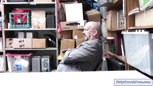 Justin Magnum in suit sits in cluttered room on StripSearchPorn