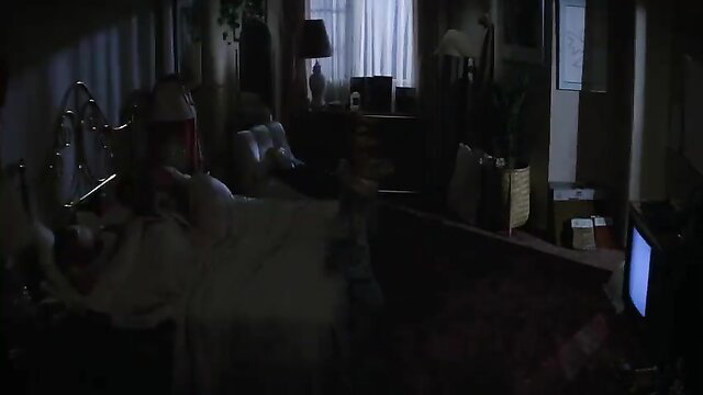Poltergeist movie bedroom scene with woman in white gown on bed