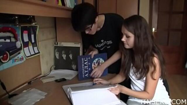 Teen brunette and black-haired guy studying books in bedroom