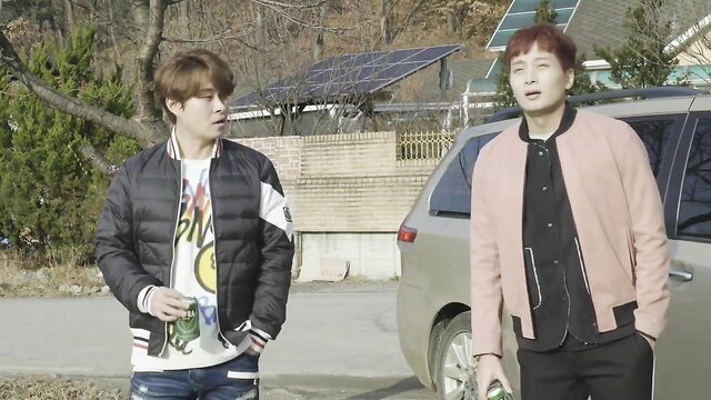 Two handsome Korean men in casual jackets outdoors