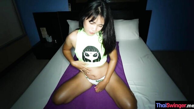 Amateur Thai babe in neon tank top & panties sits spread on bed